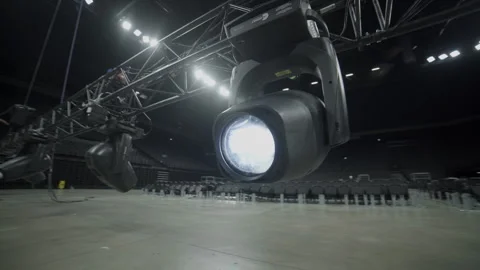 Brightly glowing lamp hangs on frame over empty stage closeup Stock Footage 326940992