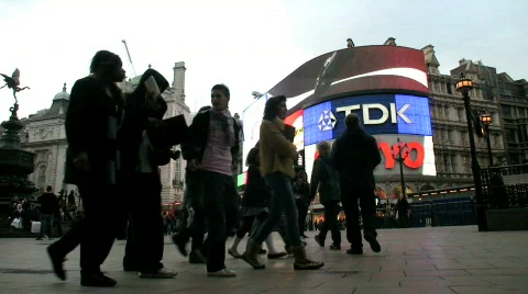 Brightly lit advertisements at dusk in Piccadilly Circus London England UK Stock Footage
