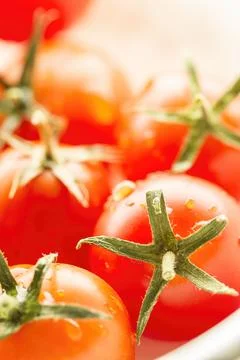 Brightly lit cherry tomatoes. Stock Photos