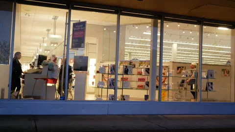 Brightly Lit Cosmetics Retail Store Front at Night During Holiday Sale Stock Footage 346197848