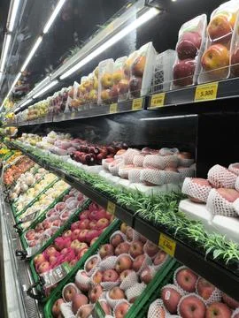 Brightly lit fruit display attracts shoppers Stock Photos
