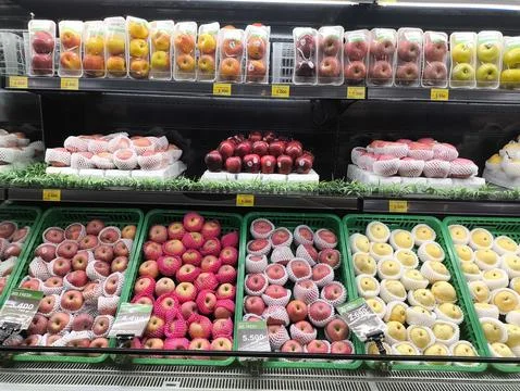 Brightly lit fruit display attracts shoppers Stock Photos