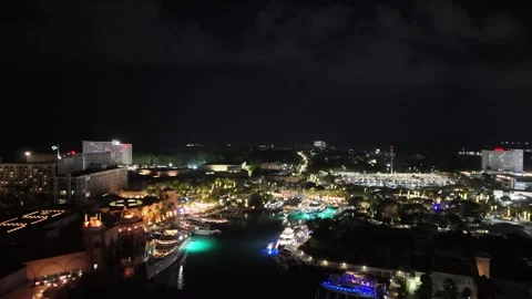 Brightly Lit Multi-Million Dollar Yachts Docked at Night Near Atlantis Resort Stock Footage 295802742
