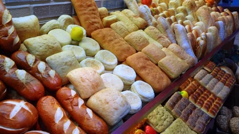 Brightly lit selection of traditional breads on a market display. A close up Stock Footage 336339389