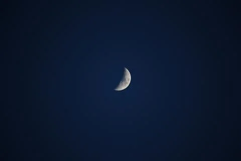 Brightly shining moon in a cloudless night sky Stock Photos