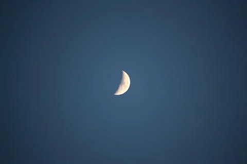 Brightly shining moon in a cloudless night sky Stock Photos