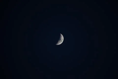 Brightly shining moon in a cloudless night sky Stock Photos