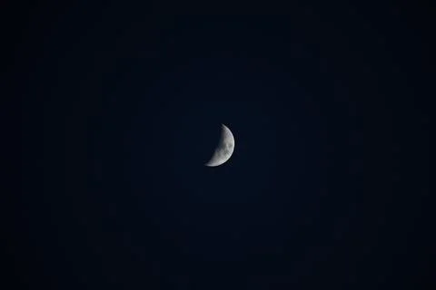 Brightly shining moon in a cloudless night sky Stock Photos