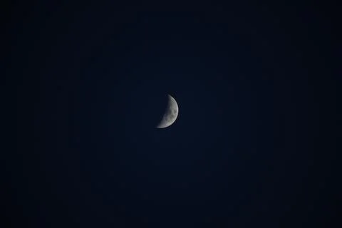 Brightly shining moon in a cloudless night sky Stock Photos