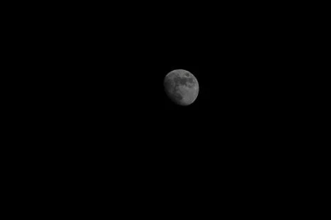 Brightly shining moon in a cloudless night sky Stock Photos