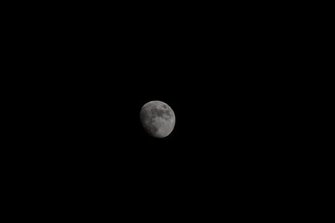Brightly shining moon in a cloudless night sky Stock Photos