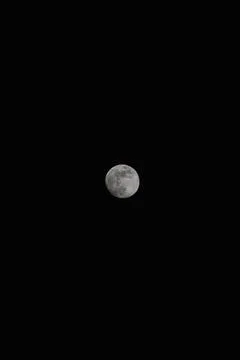 Brightly shining moon in a cloudless night sky Stock Photos