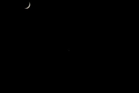 Brightly shining moon in a cloudless night sky Stock Photos