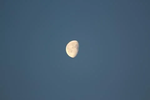 Brightly shining moon in a cloudless night sky Stock Photos