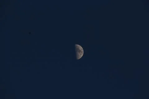 Brightly shining moon in a cloudless night sky Stock Photos