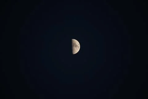 Brightly shining moon in a cloudless night sky Stock Photos