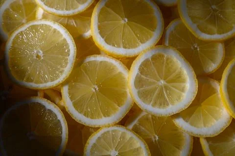 Brightly sliced lemons create a vibrant pattern in natural light during a s.. Foto stock