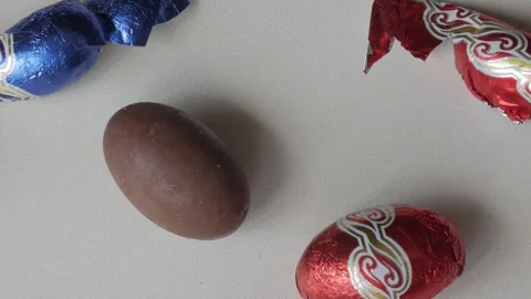 Brightly Wrapped Easter Chocolate Eggs on Display Stock Footage 331830221