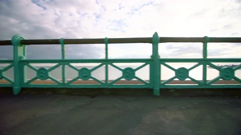 Brighton beach and pier through blue fencing Stockbeeldmateriaal 84483239