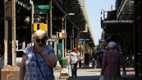 Brighton Beach elevated subway and people in Brooklyn. Street under metro Stock-Footage 341661851