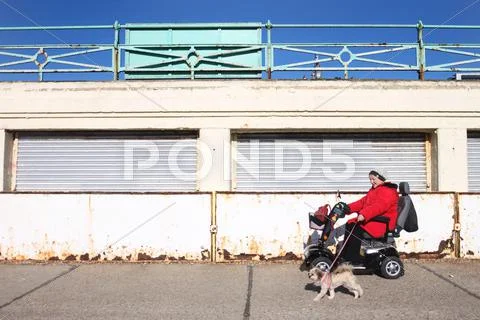 Brighton, united kingdom - feb 2: disabled woman in electric wheel chair Stock Photos