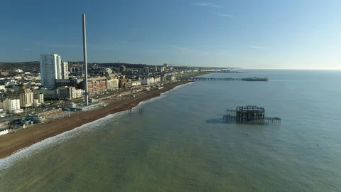 Brighton West Pier with i360 viewing tower beginning rise up, drone aerial 4K Stock Footage 101205342