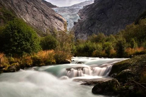 Briksdal glacier over the river Stock Photos
