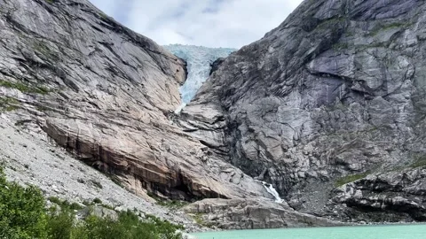 Briksdalsbreen lake rocks mountains Stock Footage 308088047