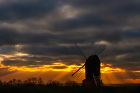 Brill mill silhouetted under dramatic skies Stock Photos