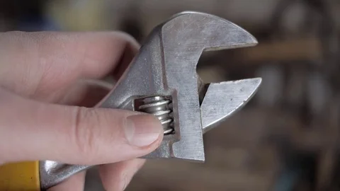 Brilliant adjustable spanner and male hands largely. Stock Footage 74066436