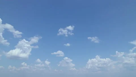 A brilliant blue sky with thin white cumulus clouds that separated. An aerial Stock Footage 204848404