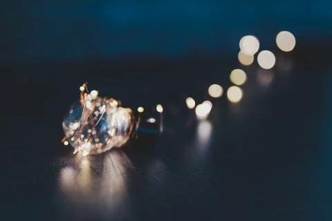Brilliant creativity, idea lightbulb wrapped up in string lights shining all  Stock Photos