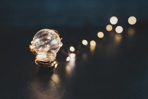 Brilliant creativity, idea lightbulb wrapped up in string lights shining all  Stock Photos