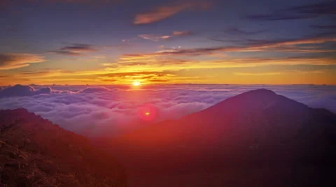 Brilliant dawn, sun rising over mountain range time lapse, Maui, Hawaii Stock Footage