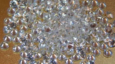 Brilliant diamonds in the light on a gold background closeup Stock Footage 81096782