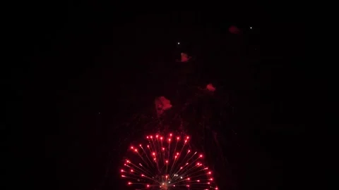Brilliant firework bursts draw patterns in dark evening sky on holiday party Stock Footage 317912140