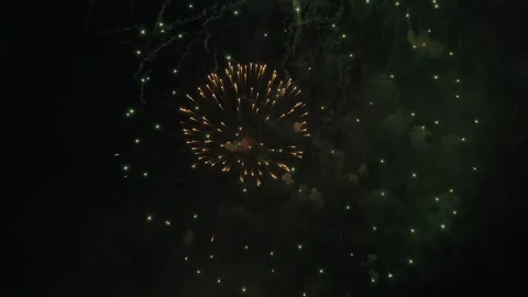 Brilliant golden firework burst with glowing sparks in dark sky Stock Footage 334590261