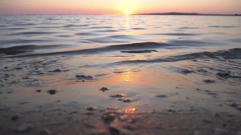 Brilliant golden sunset casting warm light over calm ocean waters Stock Footage 337417502