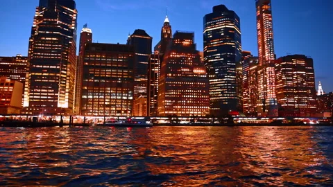 Brilliant illumination of night New York reflecting in the East River Stock Footage 318089757