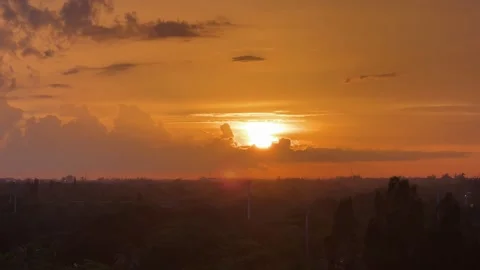 Brilliant Orange Sun Sets Behind Drifting Clouds, Golden Light Spreads Acros Stock Footage 342205415