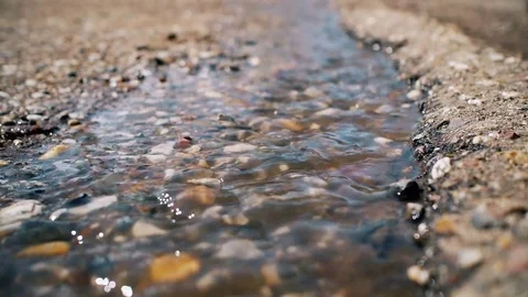 Brilliant spring stream on the asphalt Stock Footage 75025492
