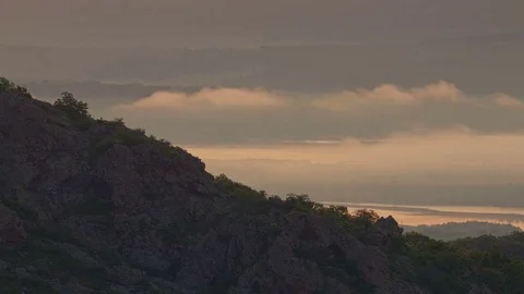 Brilliant summit sunrise time lapse above flowing foggy waves in mountain valley Stock Footage 81487735