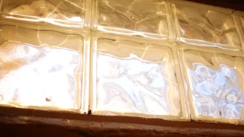 Brilliant sunlight coming through basement glass block windows Stock Footage 307714499