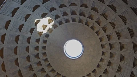 Brilliant sunlight filtering through marble oculus, casting warm shadows across Video stock 343850722