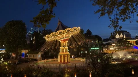 Brilliantly Illuminated Swing Carousel Ride At Tivoli Gardens On A Summer Night Stock Footage 336893456