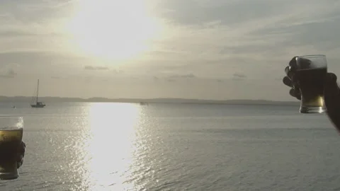 Brinde de cerveja e beira mar ao por do sol 動画素材 169030503