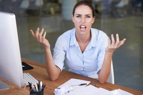 Bring me solutions not problems. Portrait of an angry businesswoman sitting at Stock Photos