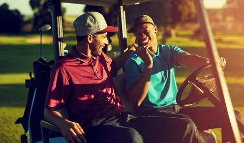 Bring on the Par-Tee. two golfers riding in a cart on a golf course. Stock Photos