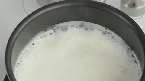 Bringing milk to the boil Stock Footage 24666233
