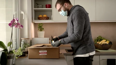 Bringing A Pandemic Supply Box To The Kitchen And Unpacking It Stock Footage 140258231